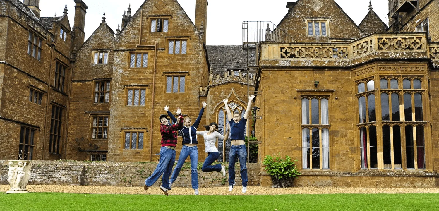 Students on the lawn in front of the Wroxton Abbey facade